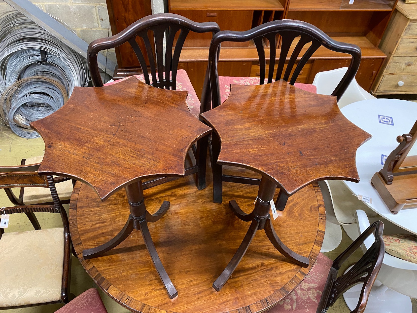 A pair of Regency style mahogany tripod wine tables with shaped circular tops, width 50cm, height 72cm